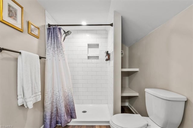 bathroom with toilet and walk in shower