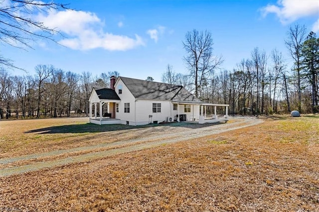 rear view of house featuring a patio and a lawn