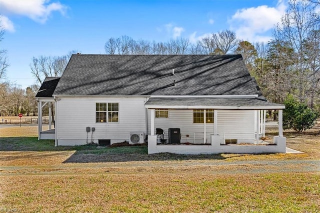 rear view of property with ac unit, a yard, central AC unit, and covered porch