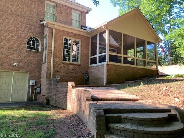 back of house with a sunroom