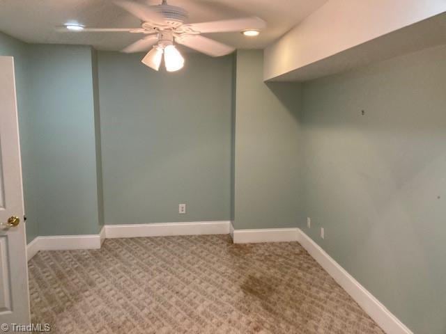 interior space with carpet flooring and ceiling fan