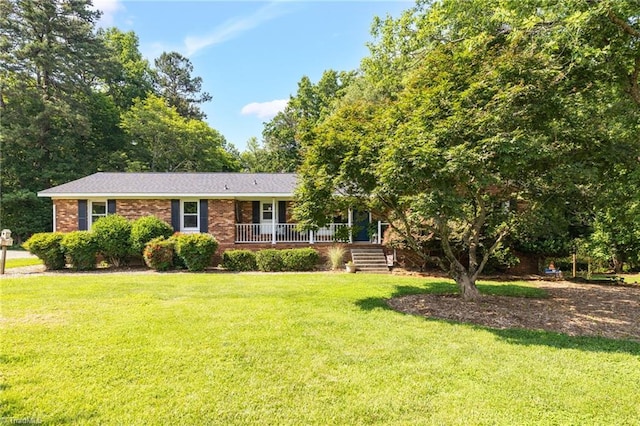 8194 Brotherstwo Rd, Colfax, NC 27235 - view of front of house featuring a front lawn, brick siding, and a porch