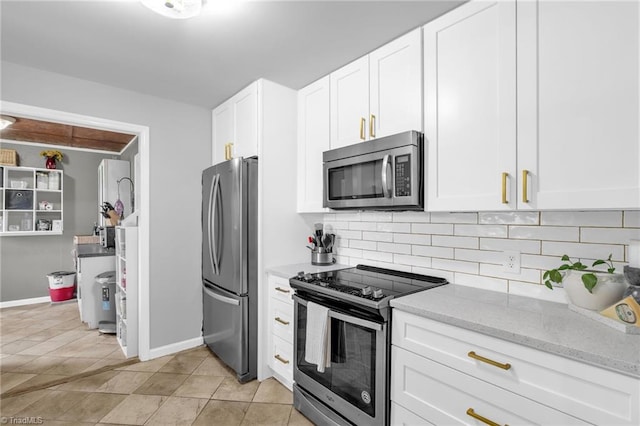 8194 Brotherstwo Rd, Colfax, NC 27235 - kitchen with appliances with stainless steel finishes, decorative backsplash, light stone counters, and white cabinetry