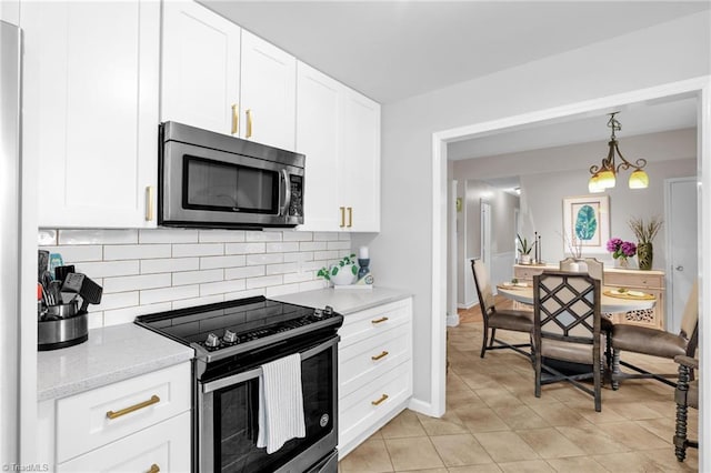 8194 Brotherstwo Rd, Colfax, NC 27235 - kitchen with appliances with stainless steel finishes, backsplash, white cabinetry, light tile patterned flooring, and light stone countertops