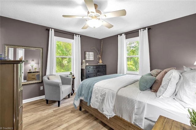 8194 Brotherstwo Rd, Colfax, NC 27235 - bedroom with light wood-style flooring and a ceiling fan