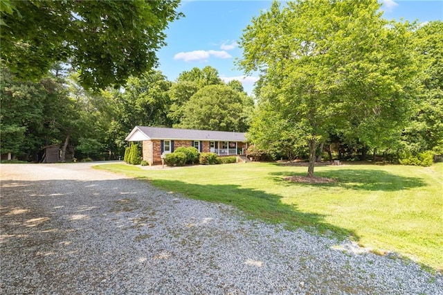 8194 Brotherstwo Rd, Colfax, NC 27235 - ranch-style house featuring a front yard, brick siding, and gravel driveway