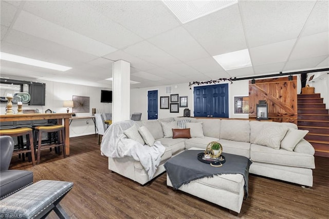 8194 Brotherstwo Rd, Colfax, NC 27235 - living area with a drop ceiling, a barn door, wood finished floors, and stairway