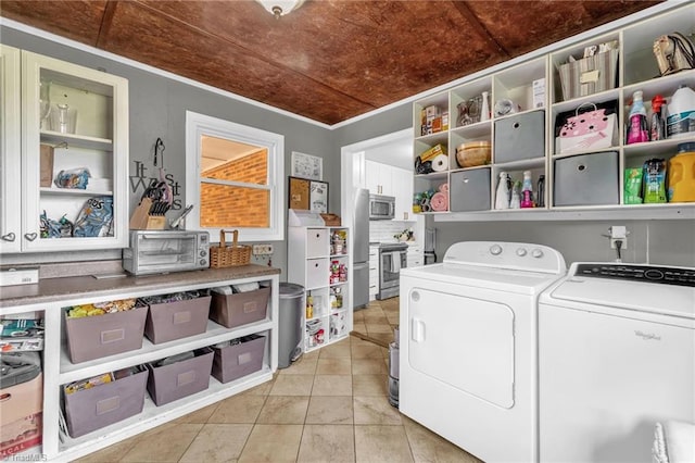 8194 Brotherstwo Rd, Colfax, NC 27235 - laundry area with separate washer and dryer, light tile patterned floors, and ornamental molding