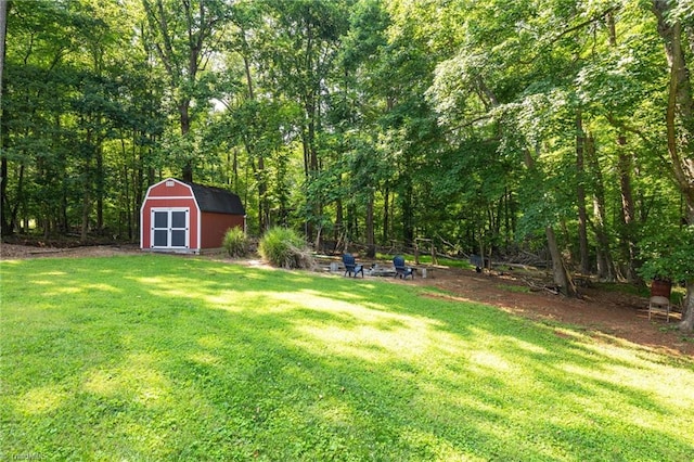 8194 Brotherstwo Rd, Colfax, NC 27235 - view of green lawn featuring a storage shed and a view of trees