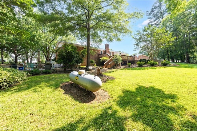 8194 Brotherstwo Rd, Colfax, NC 27235 - view of green lawn featuring stairs and a deck