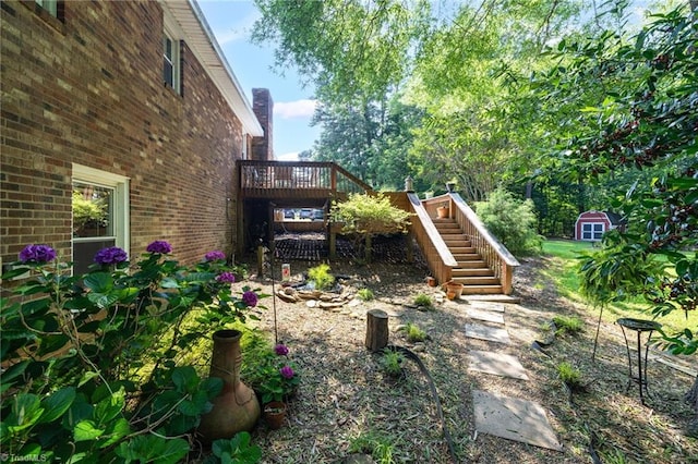 8194 Brotherstwo Rd, Colfax, NC 27235 - view of yard with stairway, a storage shed, and a deck