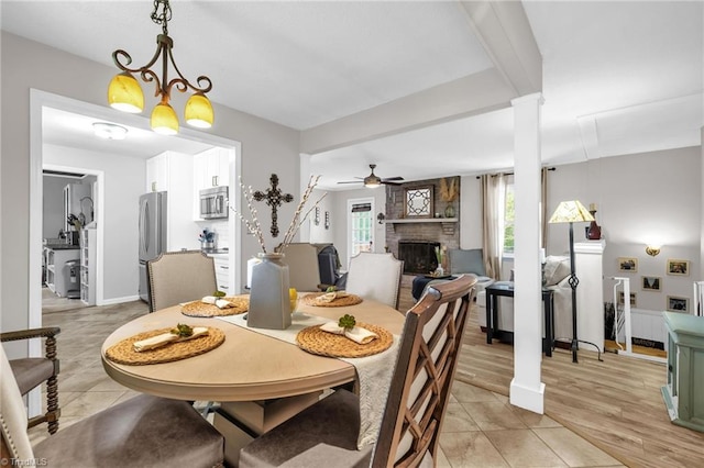 8194 Brotherstwo Rd, Colfax, NC 27235 - dining space with ceiling fan, a fireplace, and light tile patterned flooring