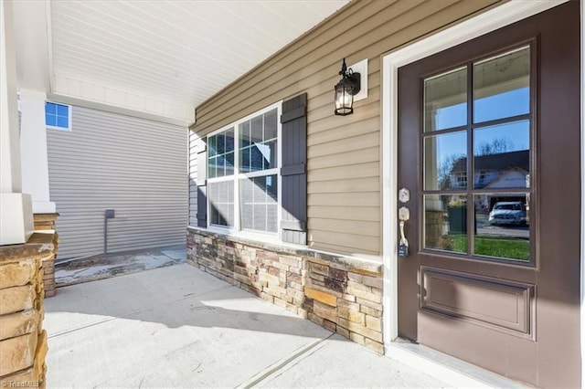 view of exterior entry featuring a porch