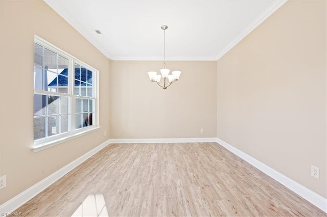 unfurnished room with wood-type flooring, ornamental molding, and a notable chandelier