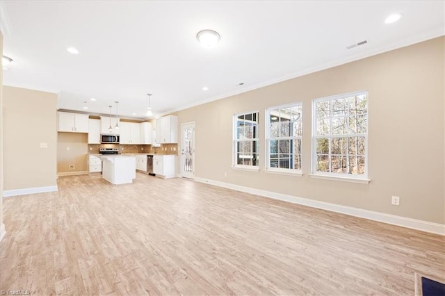 unfurnished living room with light wood-type flooring and crown molding