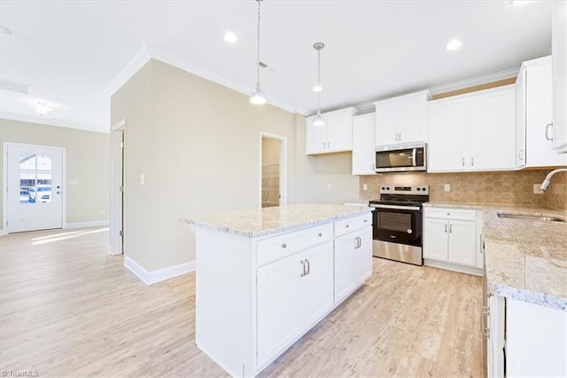 4119 Stallion St Lot 13, High Point, NC 27262 - kitchen with stainless steel appliances, crown molding, tasteful backsplash, light wood-style flooring, and light stone counters