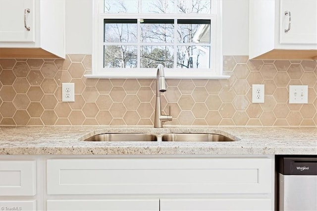 kitchen with white cabinetry, stainless steel dishwasher, tasteful backsplash, and sink