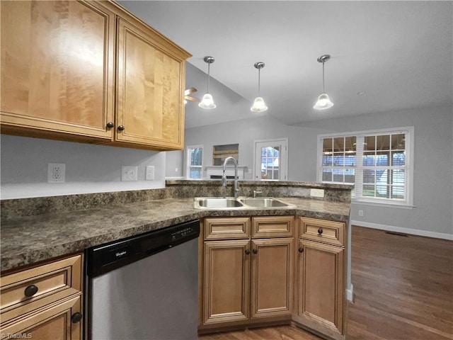 kitchen with dark countertops, decorative light fixtures, a sink, and stainless steel dishwasher