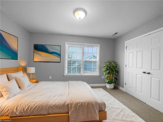 carpeted bedroom featuring visible vents and baseboards