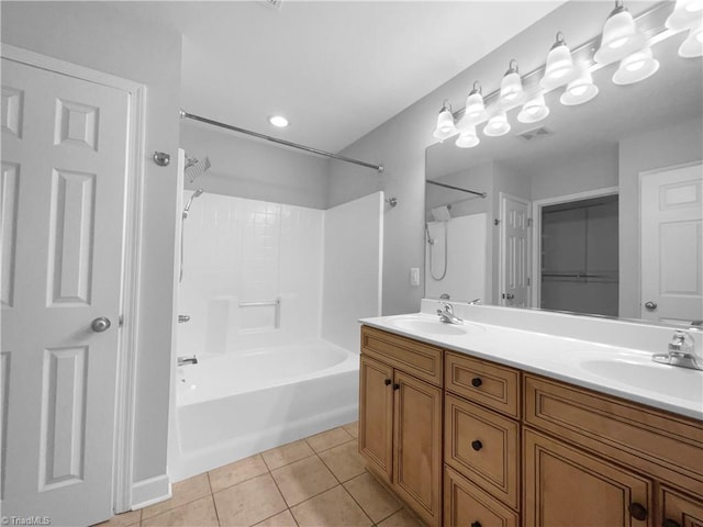 full bathroom featuring double vanity, tile patterned flooring, visible vents, and a sink