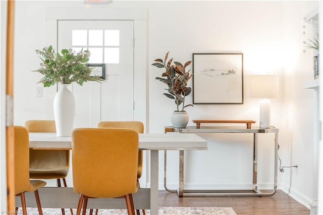 dining space with wood-type flooring