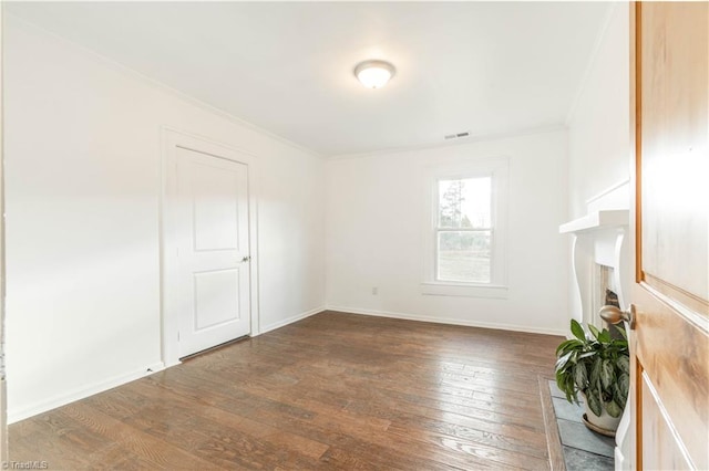 unfurnished living room featuring hardwood / wood-style floors and ornamental molding