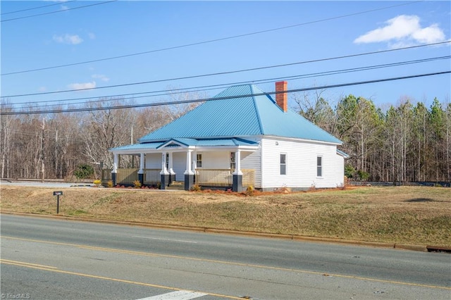 view of front of house with a front yard and a porch