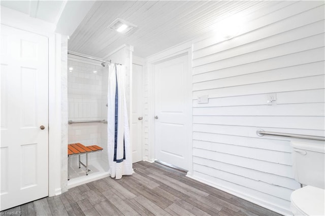 bathroom featuring wood-type flooring and toilet