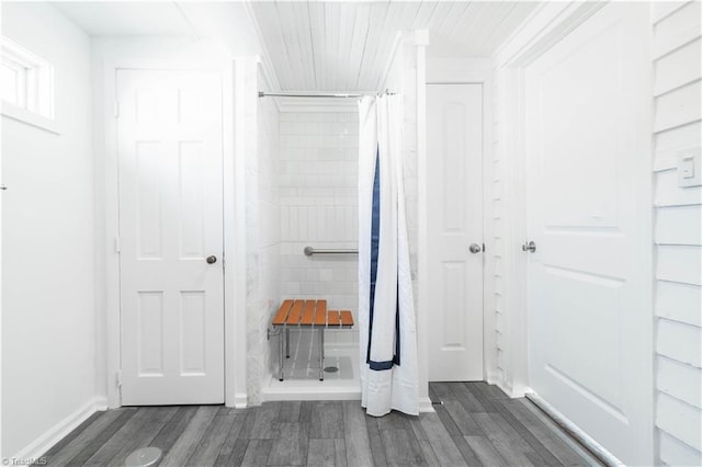 bathroom featuring walk in shower and hardwood / wood-style flooring