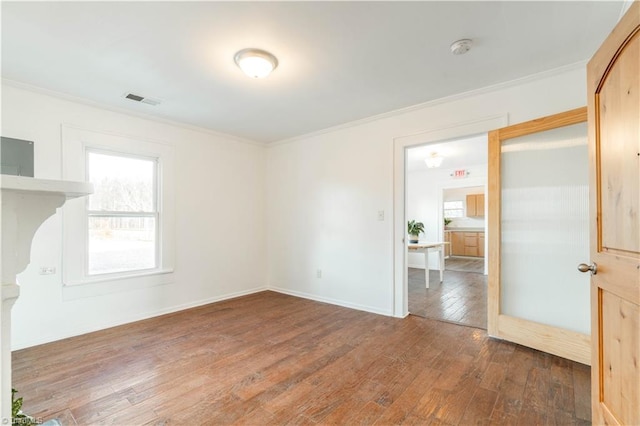 unfurnished room with ornamental molding and dark wood-type flooring