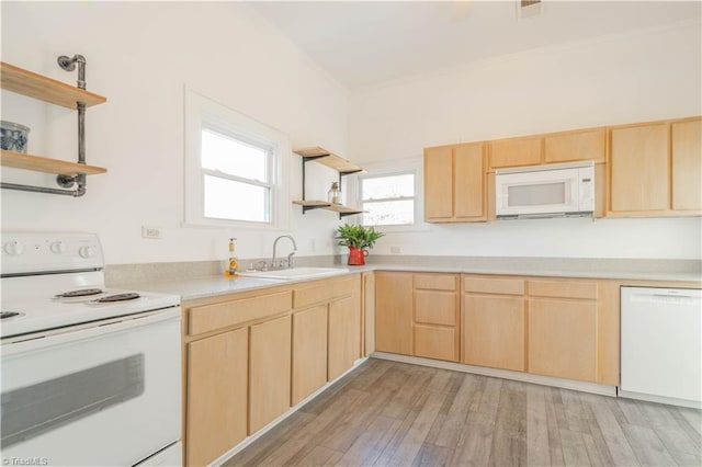 kitchen featuring light brown cabinets, sink, white appliances, and light hardwood / wood-style flooring