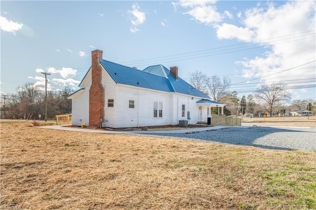 rear view of property featuring a lawn