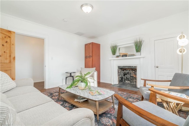 living room with dark hardwood / wood-style floors and ornamental molding