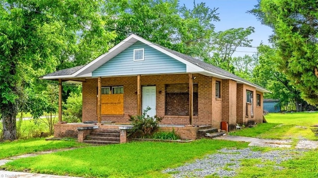218 Robin Cir, Salisbury, NC 28144 - view of front of house featuring covered porch, a front yard, and brick siding