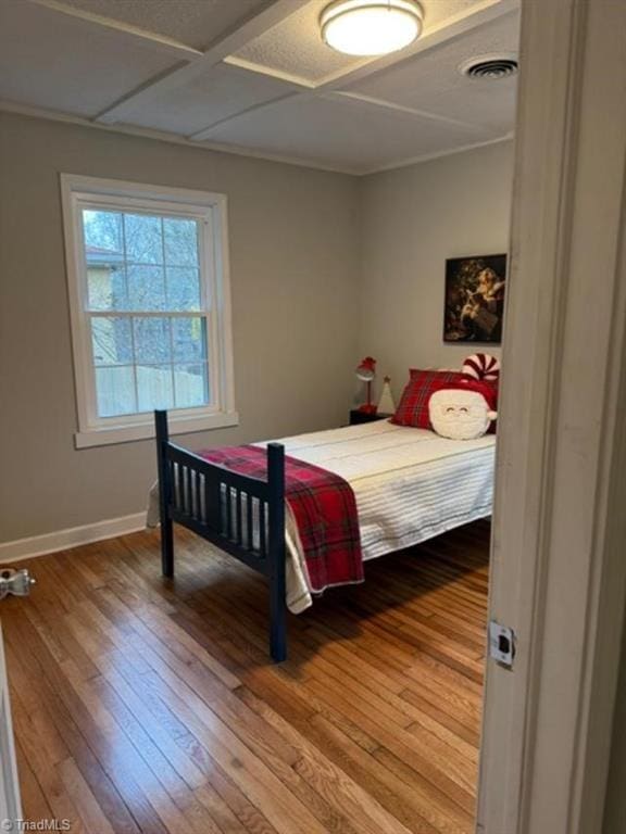 bedroom with wood-type flooring