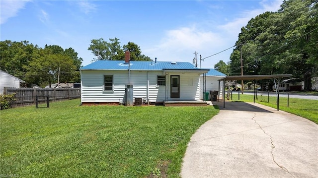 626 State Ave, High Point, NC 27262 - view of front facade with a carport, concrete driveway, a chimney, a metal roof, and covered porch