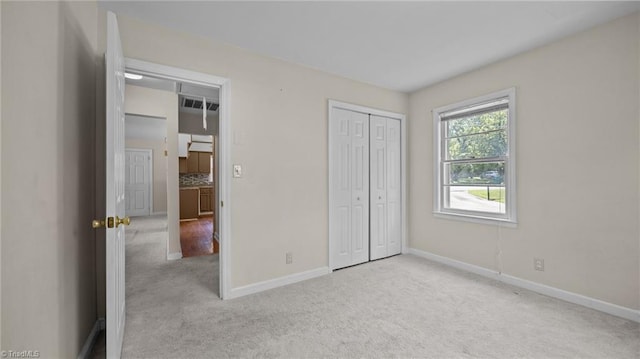 626 State Ave, High Point, NC 27262 - unfurnished bedroom with light colored carpet and a closet