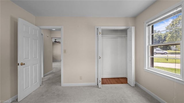 626 State Ave, High Point, NC 27262 - unfurnished bedroom featuring light carpet, multiple windows, and a closet
