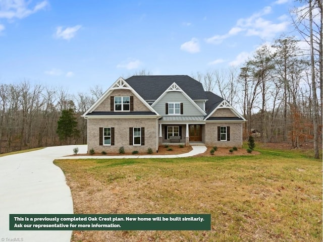 view of front of home featuring a porch, a front yard, and a standing seam roof