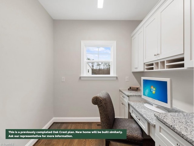 office featuring baseboards, built in desk, and wood finished floors