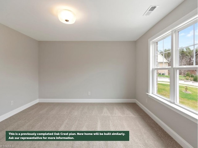 spare room featuring light carpet, baseboards, and visible vents