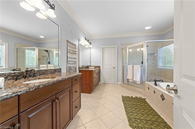 full bathroom featuring a garden tub, tile patterned flooring, a shower stall, two vanities, and a sink