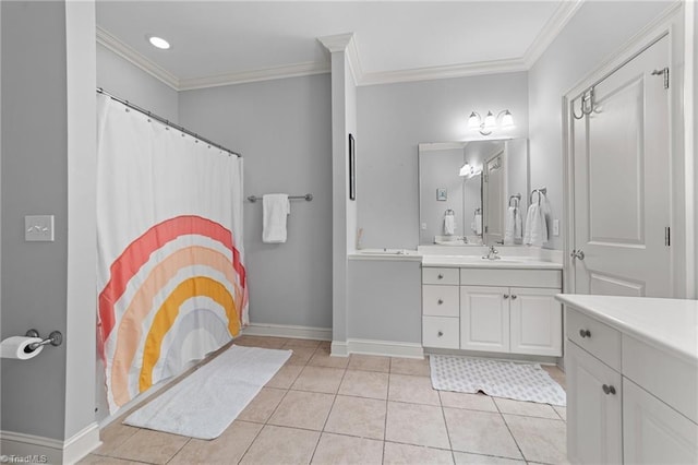 bathroom with tile patterned flooring, ornamental molding, baseboards, and vanity