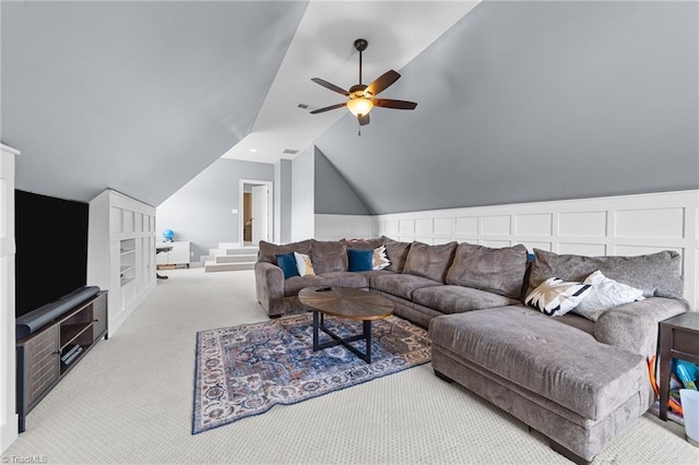 carpeted living room with ceiling fan, visible vents, and lofted ceiling