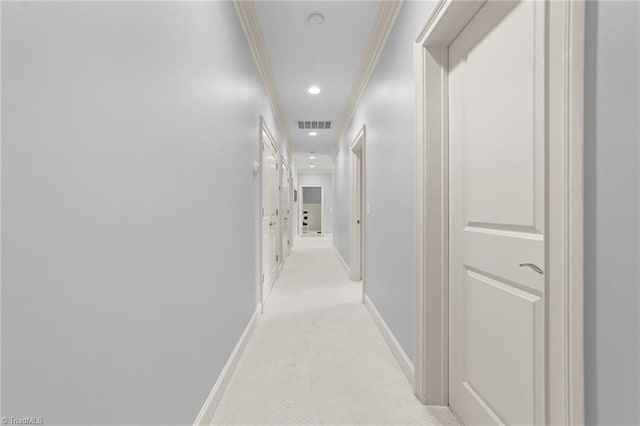 hallway with crown molding, light carpet, recessed lighting, baseboards, and visible vents