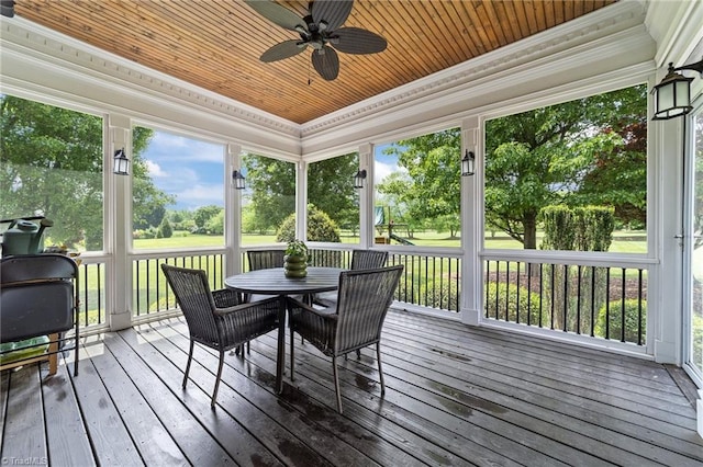 sunroom / solarium with ceiling fan, outdoor dining space, and a wealth of natural light