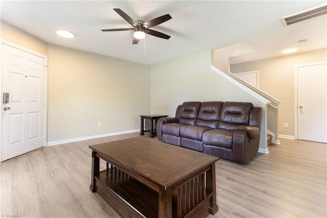 3602 Turquoise Dr, Durham, NC 27703 - living room featuring light wood-type flooring, a ceiling fan, baseboards, and stairway