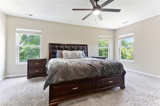 3602 Turquoise Dr, Durham, NC 27703 - carpeted bedroom featuring baseboards, ceiling fan, and a textured ceiling