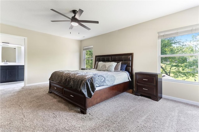 3602 Turquoise Dr, Durham, NC 27703 - bedroom featuring light colored carpet, baseboards, ceiling fan, and ensuite bathroom