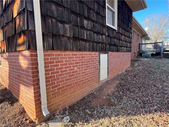 view of home's exterior with a wooden deck and cooling unit